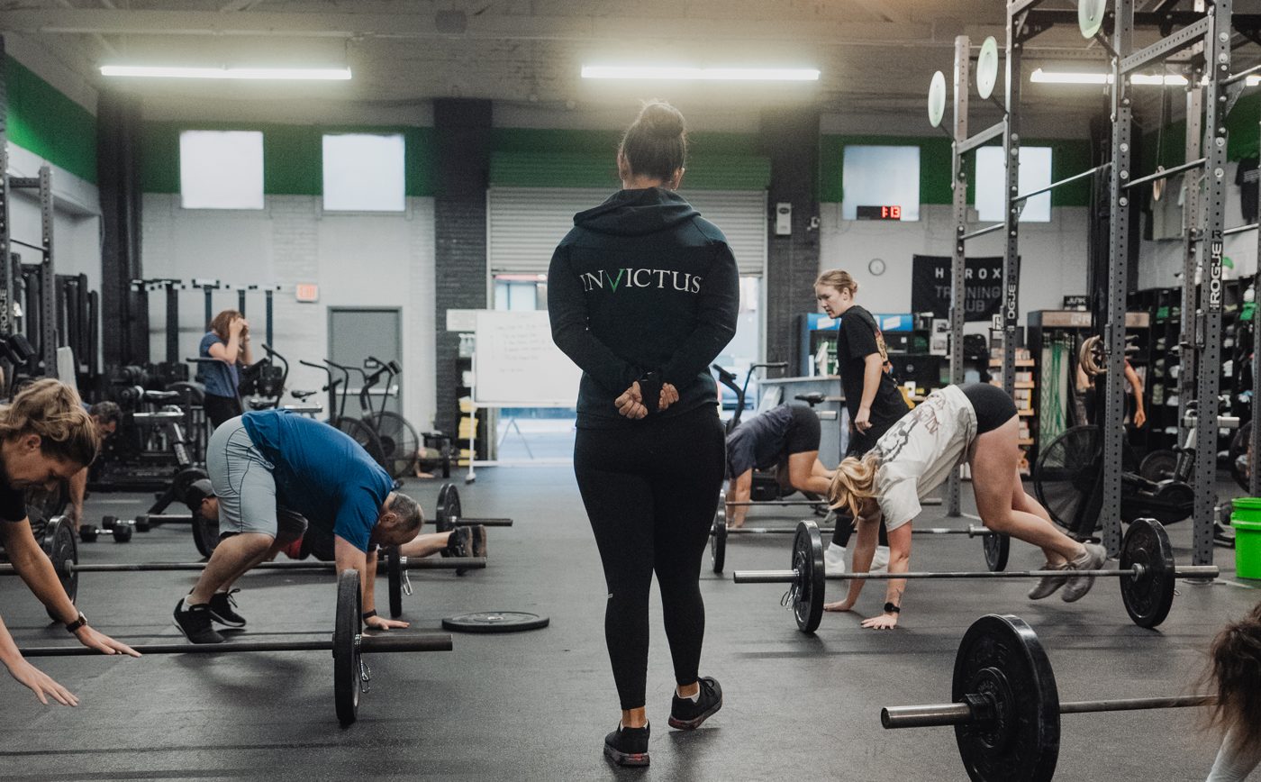 A coach leading a class at Invictus Fitness